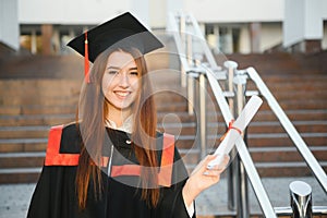 Happy graduation day for a young woman very beautiful with graduation cap smile large in front of the Camera posing