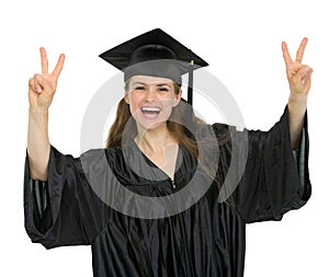 Happy graduation student showing victory gesture
