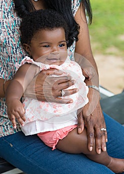 Happy Granddaughter on Grandmother's Lap