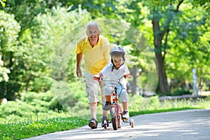 Happy grandfather and child in park