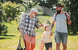 Happy grandfather, father and grandson with fishing rods. Anglers. Men day. Grandfather, father and son are fishing.