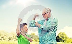 Happy grandfather and grandson showing muscles