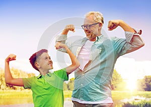 Happy grandfather and grandson showing muscles