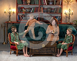 Happy grandma and grandchildren reading book together at home