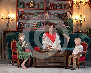 Happy grandma and grandchildren reading book together at home