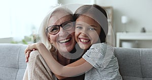 Happy grandmother and granddaughter express care and love on camera