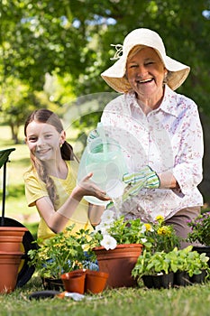 Happy grandmother with her granddaughter gardening