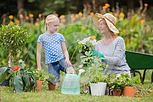 Happy grandmother with her granddaughter gardening