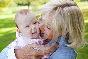 Happy grandmother holding cute baby