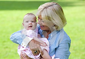 Happy grandmother holding cute baby