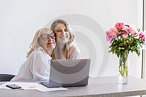 Happy grandmother hugging her young granddaughter