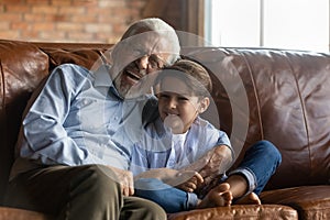 Happy grandpa having fun with cute preschooler grandson