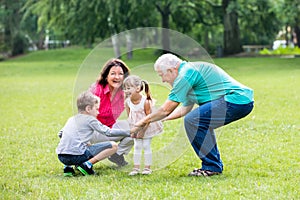 Happy Grandparent And Grandchildren In Park photo