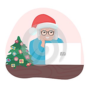Happy granny with Christmas hat looking at laptop. Old woman with glasses speaking online. Holiday communication with family.
