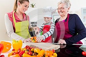 Granny showing old family recipe to grandson and daughter