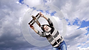 Happy greybeard man pretend flying on wooden airplane in sky, travelling