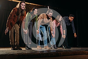 Happy group actors and actresses bowing