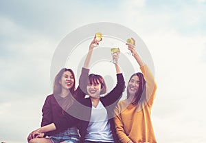 Happy group of asian girl friends enjoy laughing and cheerful sparkling wine glass at rooftop party,Holiday celebration festive,