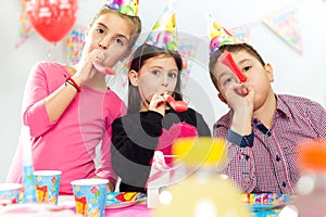 Happy group of children having fun at birthday party