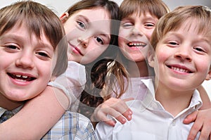 Happy group of children hugging together