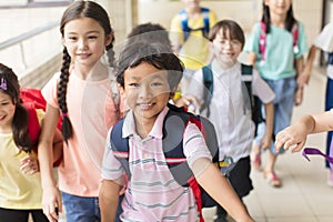 Happy Group of elementary school kids running forward