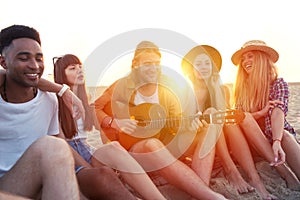 Happy group of friend having party on the beach