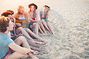 Happy group of friend having party on the beach