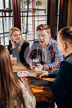 Happy group of friends drinking and clinking with beer and cocktails at brewery bar restaurant