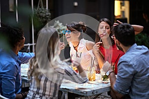 Happy group of  friends having fun with props on stick in nightclub celebrating. Party, Celebration, togetherness, socializing