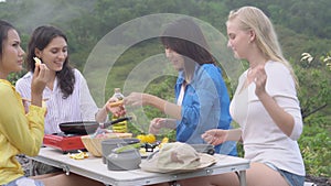 Happy with group of friends picnic with cooking food in summer, group woman enjoy and fun camping journey.