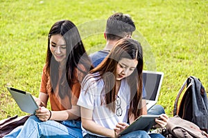 Happy group friends students sitting in park at college