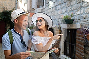 Happy group of friends tourists sightseeing in city on vacation