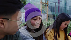 Happy group of high school asian students studying outside educational building