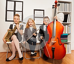 Happy group of kids playing musical instruments