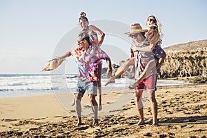 Happy group of people on vaation - youthful and funny concept with young men and women having fun together in friendship playing