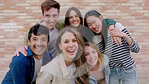 Happy group of young friends smiling at camera outdoors