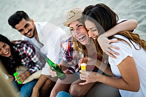 Happy group of young people having fun at beach