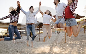 Happy group of young people having fun at beach
