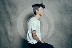 happy guy with curly hair and glasses teen model photo studio emotions Copy Space