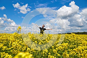 Happy guy enjoying life without pollen allergy in a rapeseed field