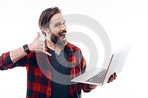 Happy Guy Hold Laptop and Showing Call Me Gesture