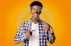 Happy Guy Holding Credit Card and Point on It