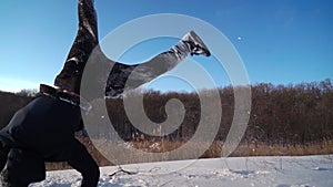 Happy Guy Runs in Snow and does Somersaults. Man is Having Fun in Winter Glade