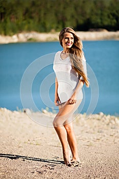 Happy hair woman on beach in a white dress