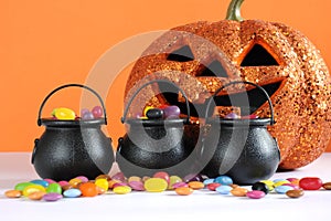 Happy Halloween candy in trick or treat carry cauldrons with pumpkin