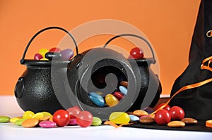 Happy Halloween candy in trick or treat carry cauldrons with witches hat