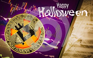 Happy Halloween cryptocurrency Trading concept. Spooky Golden bitcoin with jack-o-lantern face on smartphone with scary btc photo