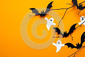 Happy Halloween day concept. Halloween decorations, paper ghosts, bats on orange background. Flat lay, top view, copy space