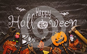 Happy Halloween day with construction DIY handy tools on black chalk board background concept. Flat lay Top view