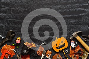 Happy Halloween day with construction DIY handy tools on black chalk board background concept. Flat lay Top view with copy space